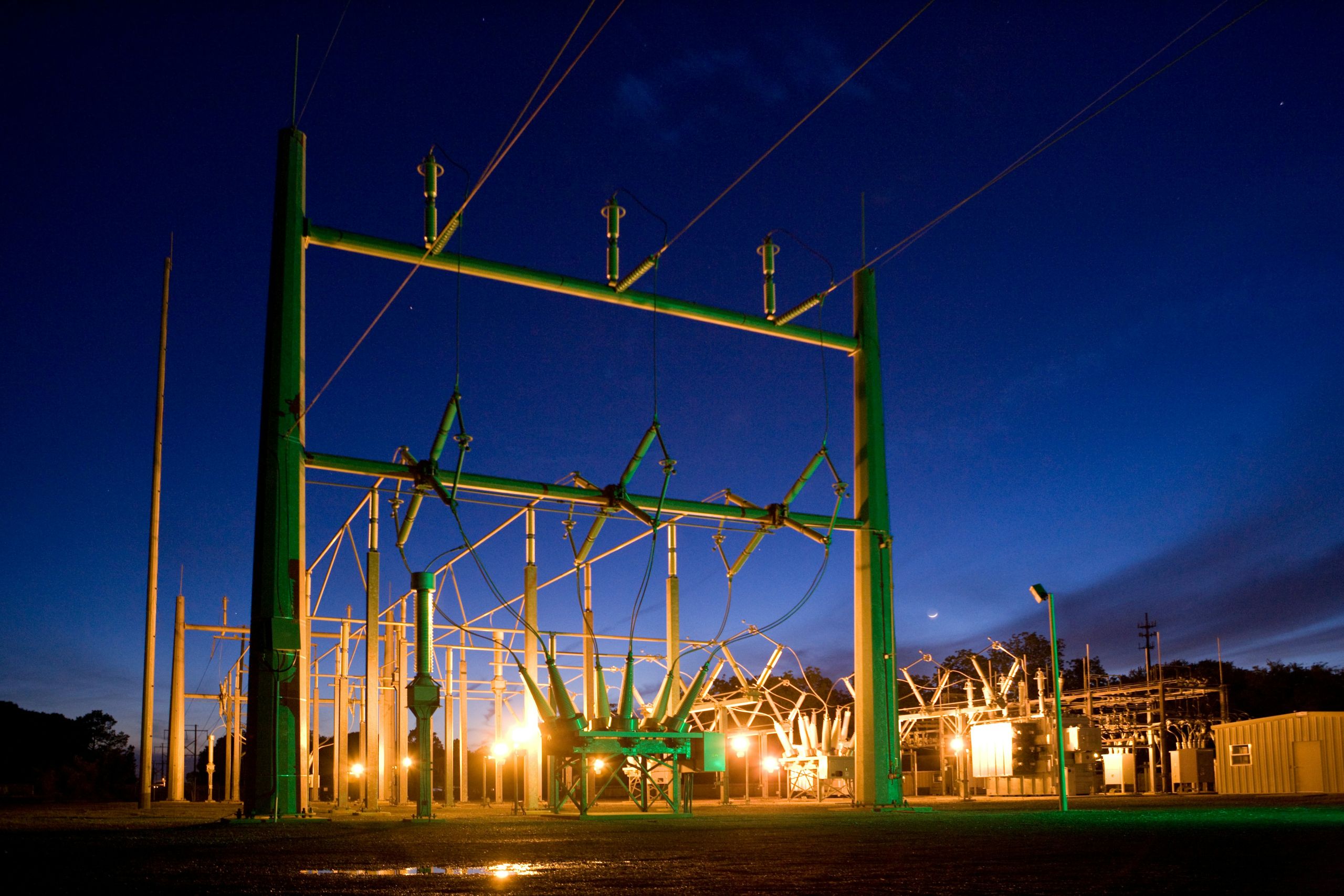 Small power transformer station lit with work lights at night