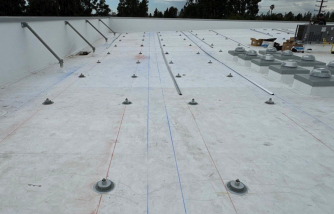 Penetration-based footing system installed on curved commercial roof, Santa Ana, California — National Energy Installers